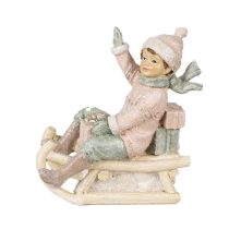   CLEEF.6PR4912 Rózsaszín ruhás kisfiú szánon, műanyag dekorfigura, 10x5x10cm